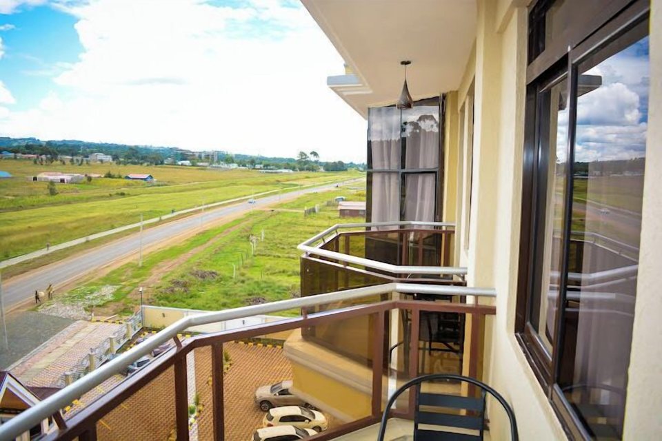 A balcony looking over the road and fields