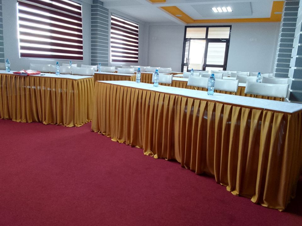 Tables dressed with gold skirting for a meeting
