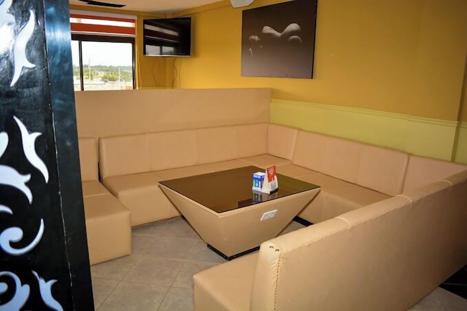 A lounge with sofa and TV