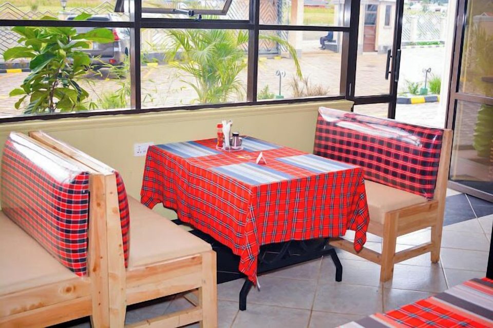A booth with red checked tablecloth