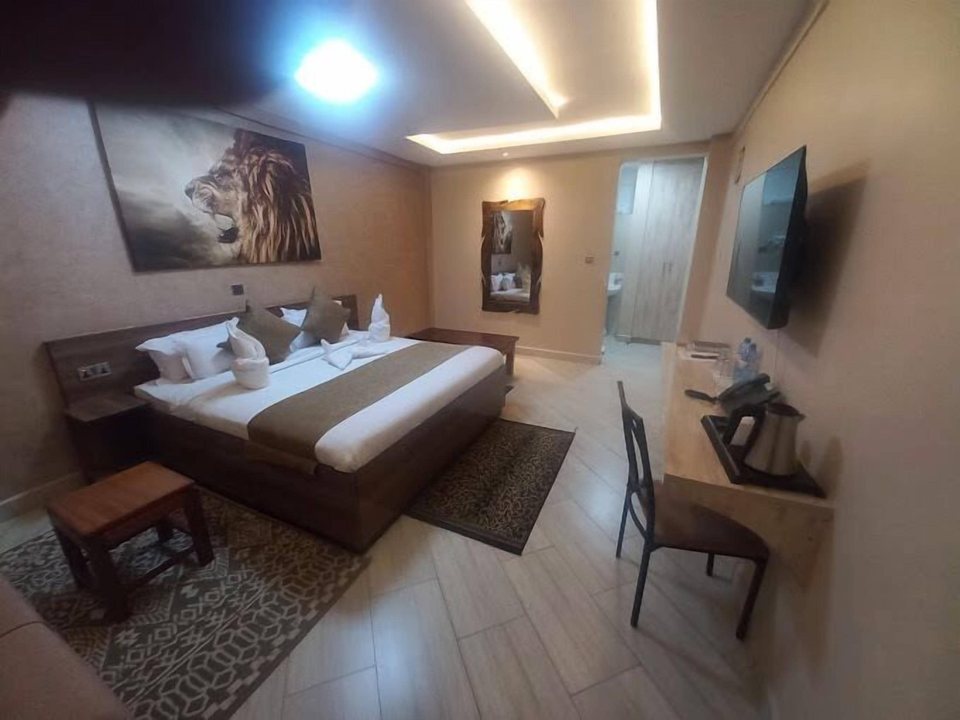 A suite with bed, desk and armchair