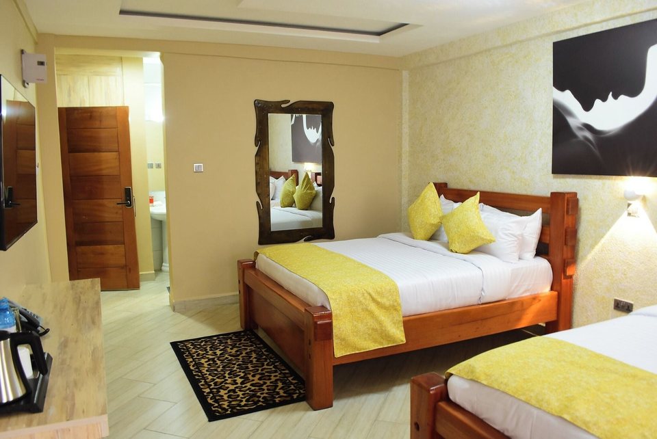 A twin room with yellow throws